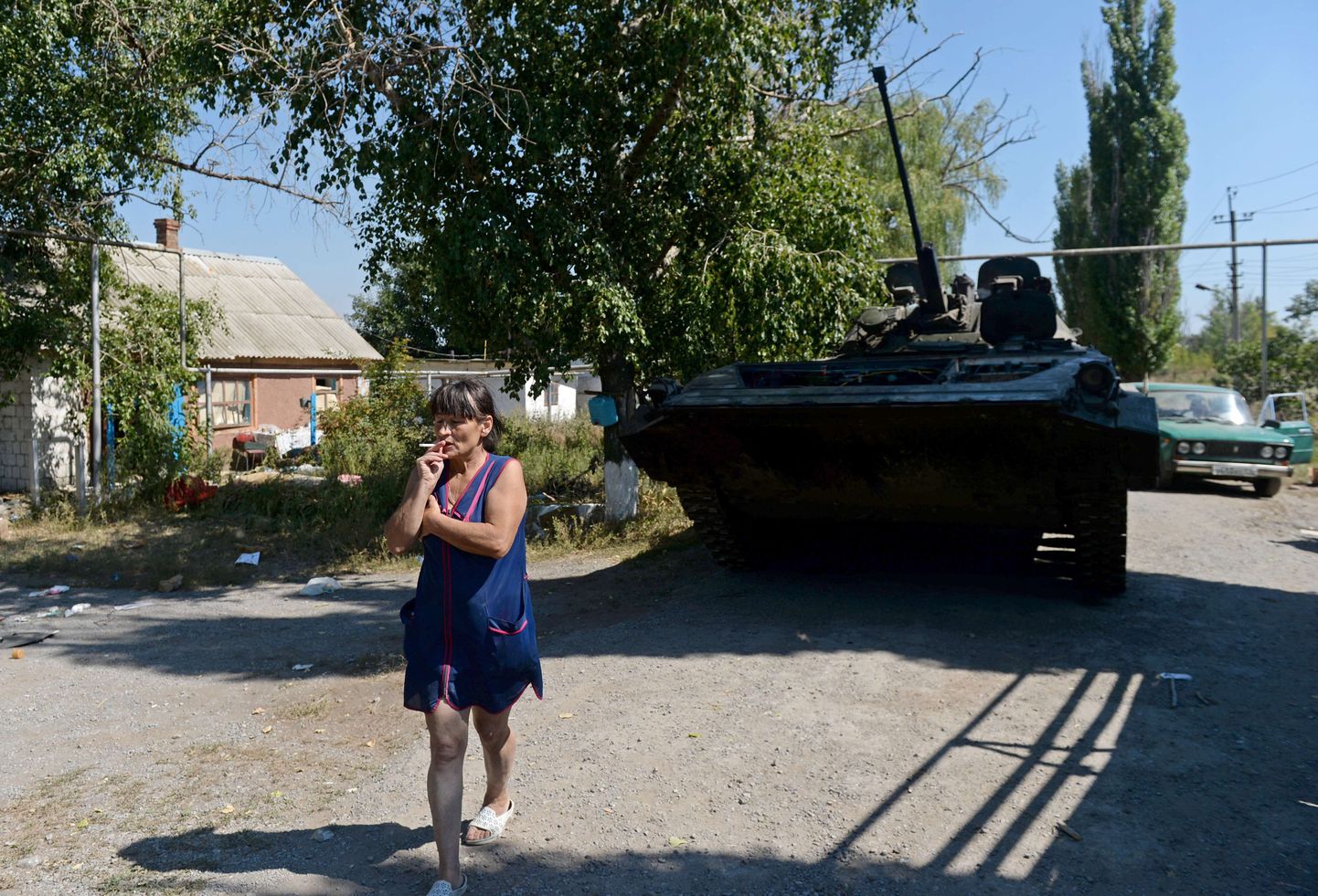 Külaelanik eile Strarobeševos Ukraina armee mahajäetud tanki ees.