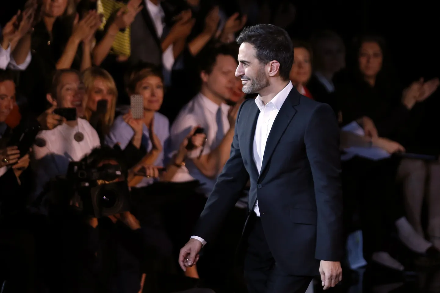 US designer Marc Jacobs acknowleges the public at the end of the Louis Vuitton 2014 Spring/Summer ready-to-wear collection fashion show, on October 2, 2013 in Paris. Jacobs is to leave Louis Vuitton to concentrate on his own brand and a future stock exchange flotation, a report said today.     AFP PHOTO / JOEL SAGET