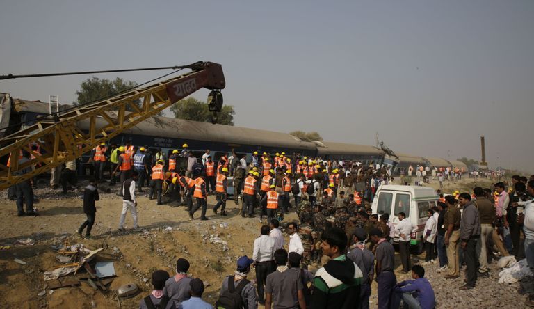 Rescuers work at the site of a train derailment accident in Kanpur Dehat, India, Sunday, Nov. 20, 2016. Many were killed Sunday when 14 coaches of an overnight passenger train rolled off the track in northern India, with rescue workers using cutting torches to try to pull out survivors, police said. (AP Photo/Rajesh Kumar Singh)