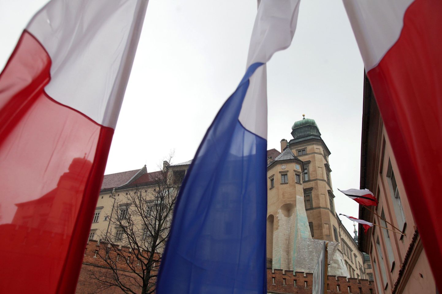 Poola lipud leinalindiga lehvimas Waweli kuningalossi ees Krakowi kesklinnas.