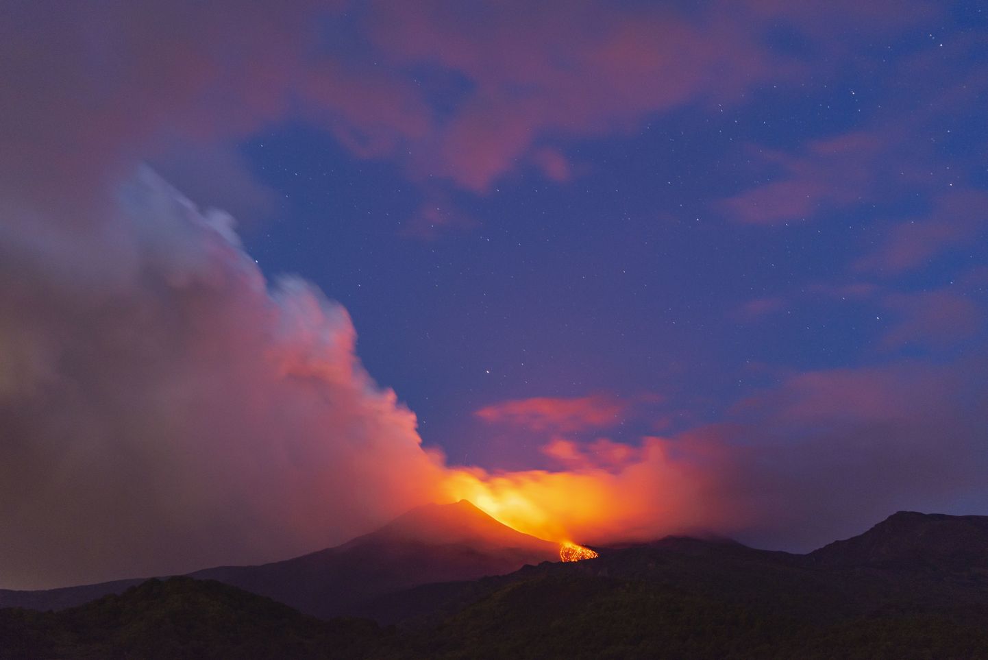 Mount Etna volcano spews lava during an eruption early Saturday, Aug. 25, 2018. Mount Etna in Sicily has roared back into spectacular volcanic action, sending up plumes of ash and spewing lava. Italy's National Institute of Geophysics and Vulcanology (INGV) says that the volcano, which initially "re-awoke" in late July, sprang into fuller action Thursday evening by shooting up chunks of flaming lava as high as 150 meters (500 feet) almost constantly. (AP Photo/Salvatore Allegra)