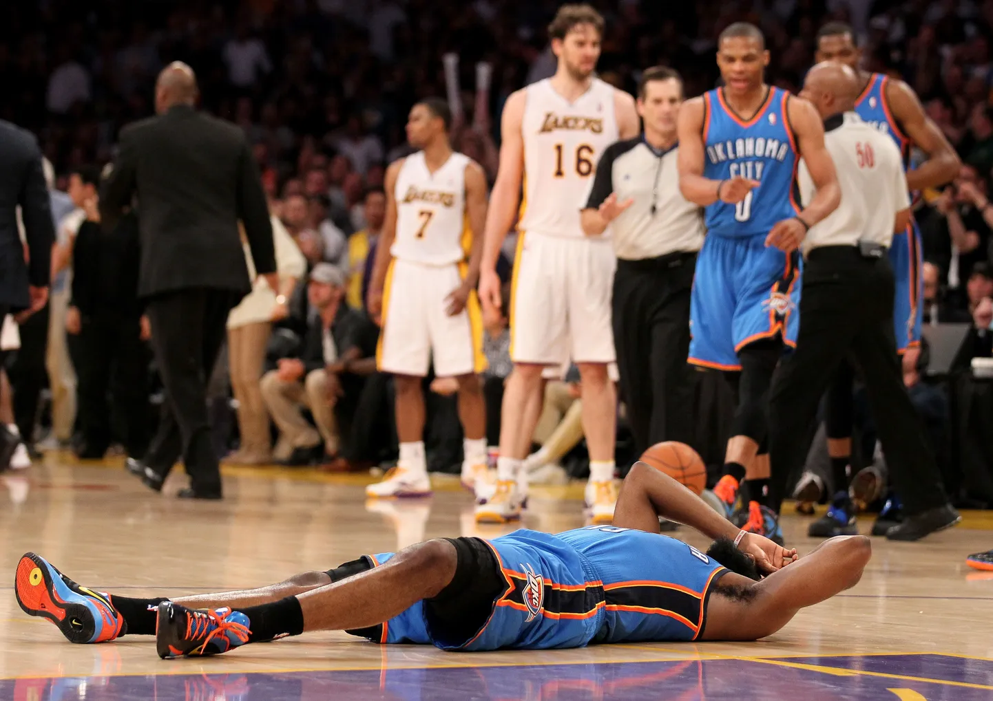 Баскетболист лежит после удара локтем в голову.