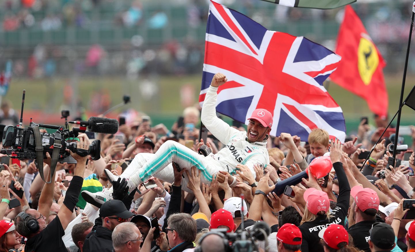 Mercedes driver Lewis Hamilton celebrates winning the British Grand Prix at Silverstone, Towcester.