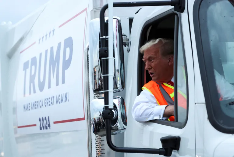 Republican presidential nominee and former U.S. President Donald Trump sits inside garbage truck, in Green Bay, Wisconsin, U.S., October 30, 2024. REUTERS/Brendan McDermid