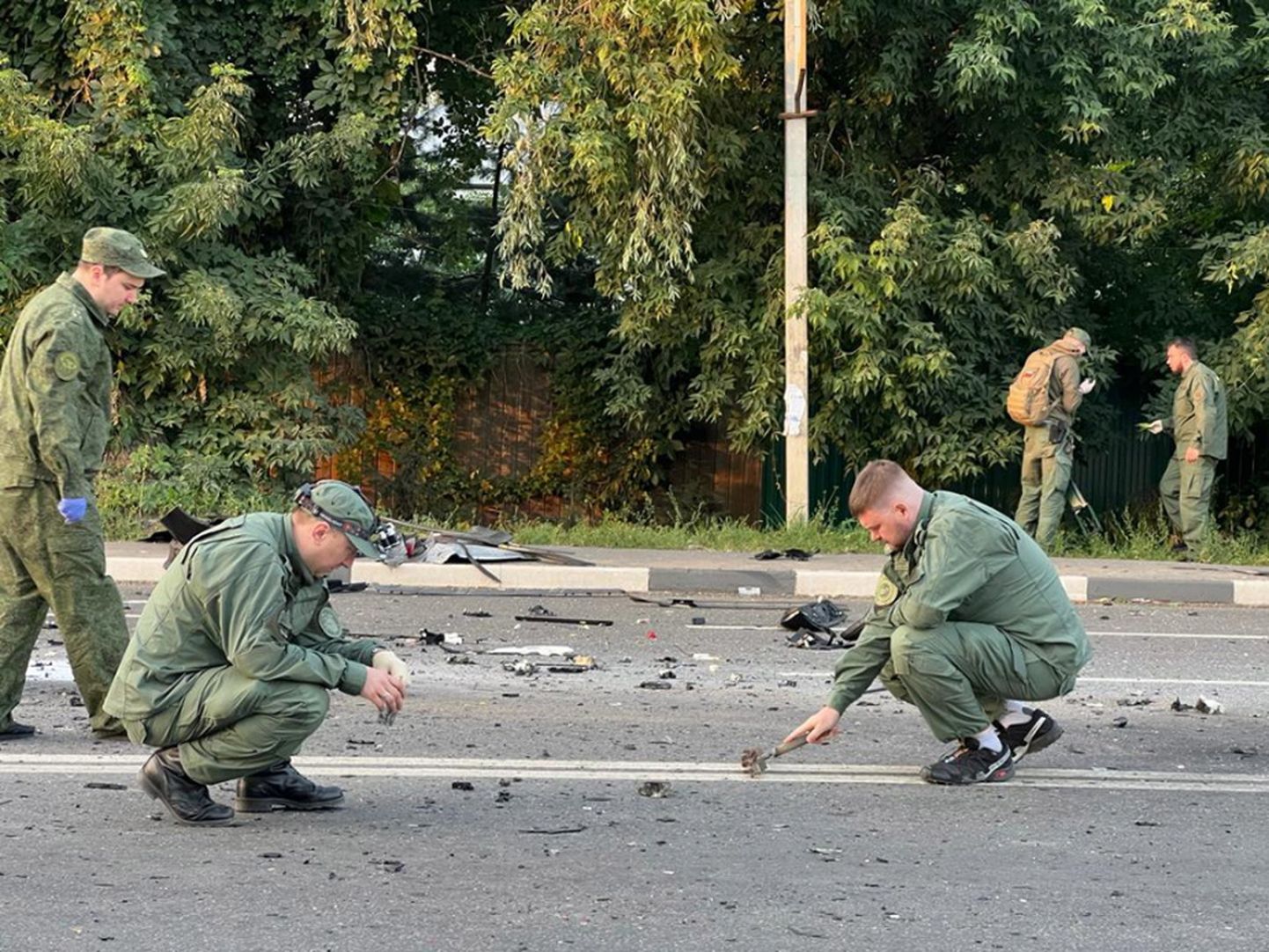 Investigators working at the scene of a car explosion on Mozhaisk highway near the village of Bolshiye Vyazemi in the Odintsovo urban district in Moscow region, Russia. In the evening of 20 August a Toyota Land Cruiser car blew up when the car was moving at full speed on a highway, and then burned. The driver Darya Dugina, the daughter of the philosopher Alexander Dugin, died on the spot.