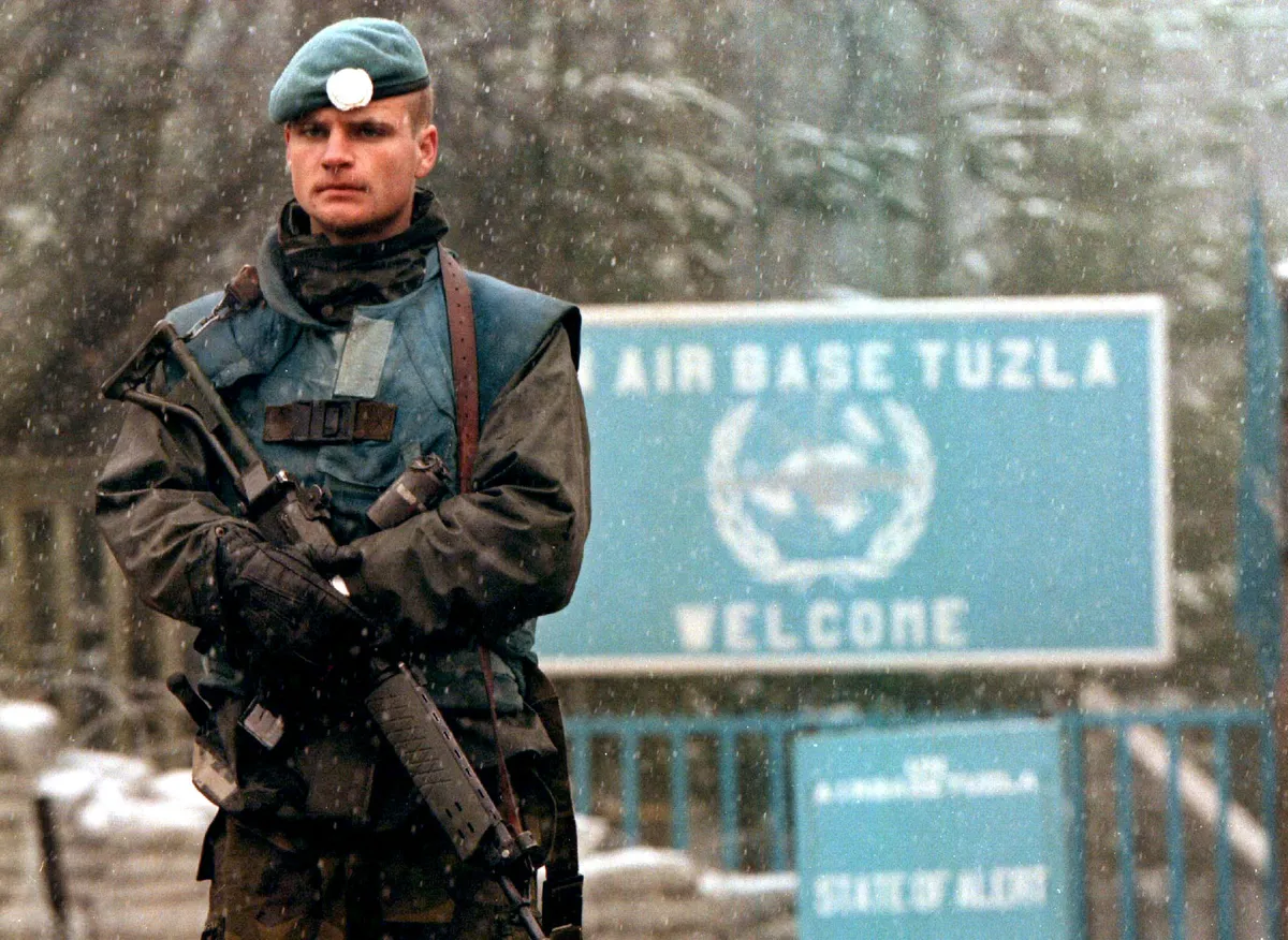 A Swedish UN soldier stands quard in front of Tuzla's air base in Bosnia. The air base housed the headquarters for up to 20,000 US troops as part of a NATO deployment to Bosnia.