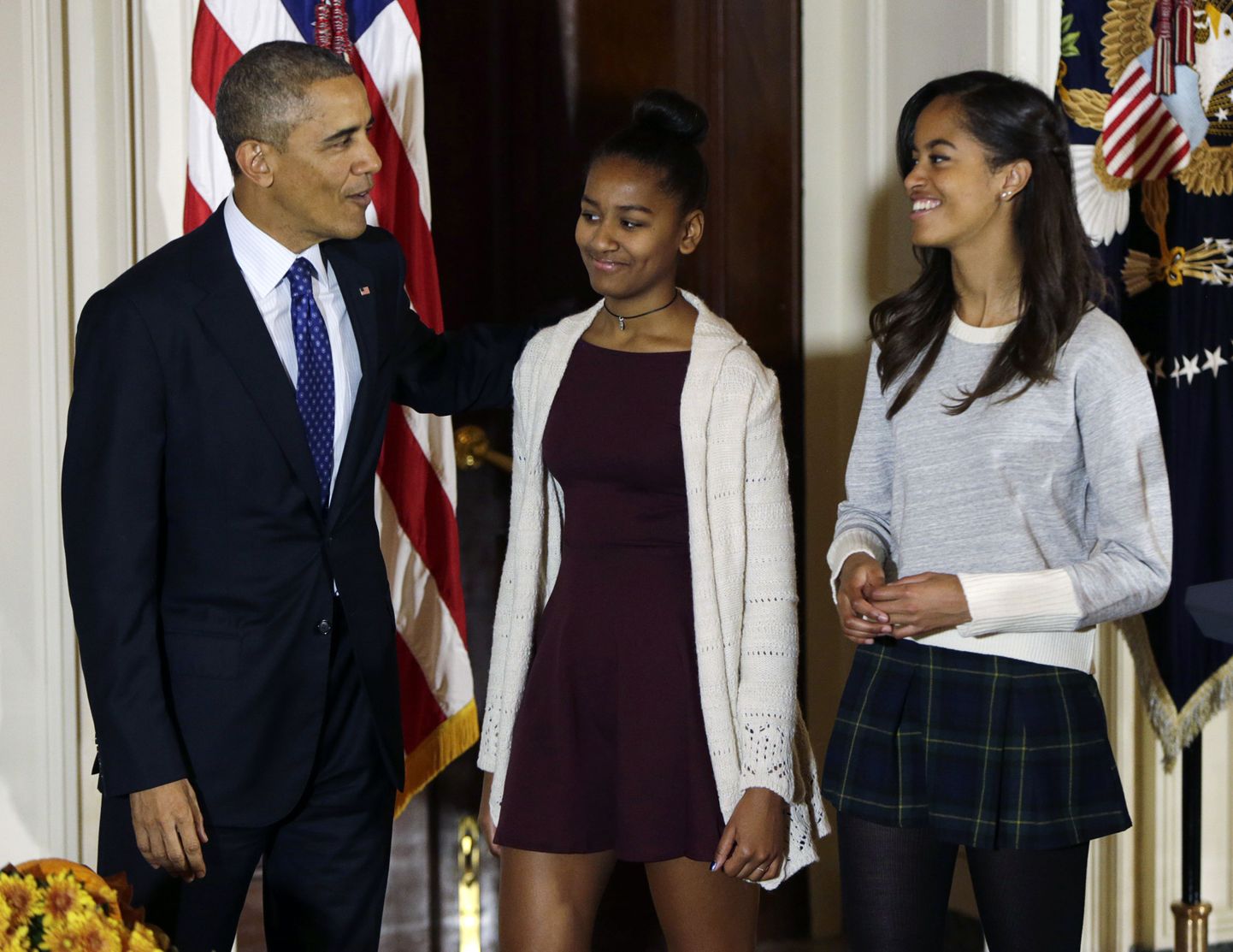 U.S. President Barack Obama's daughters Sasha and Malia (R) join their father after the pardoning of the National Thanksgiving Turkey "Cheese" at the White House in Washington November 26, 2014. REUTERS/Gary Cameron    (UNITED STATES - Tags: POLITICS SOCIETY)