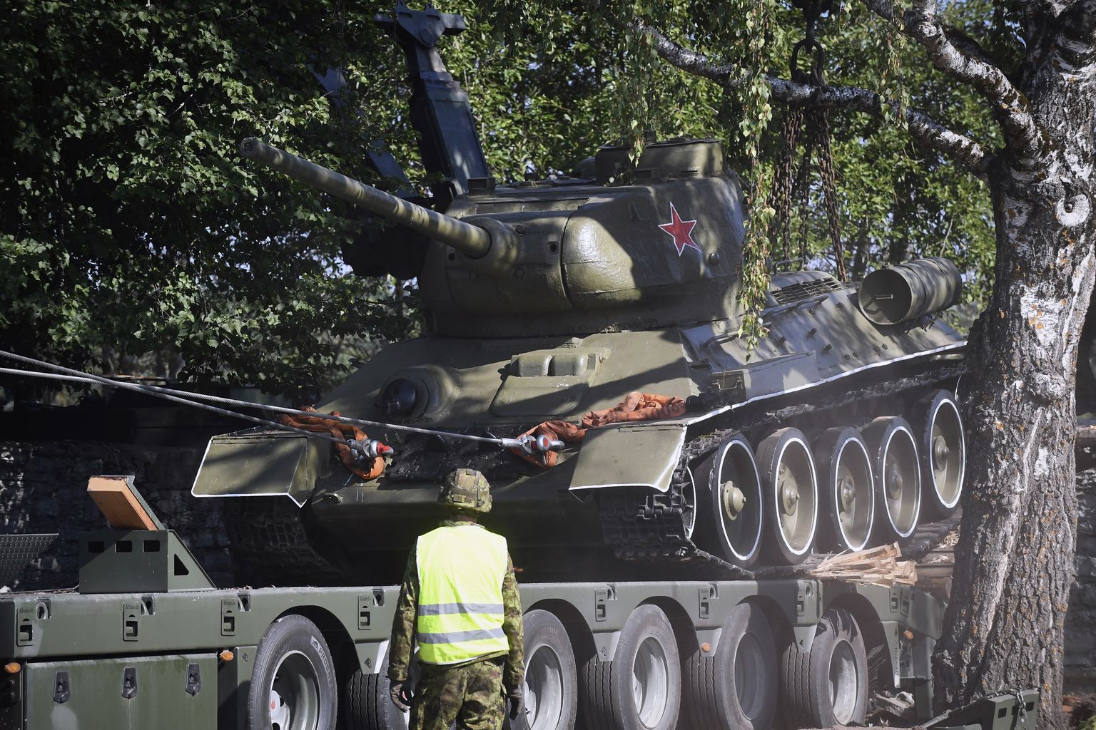 A Soviet T-34 tank installed as a monument is removed from its pedestal in Narva, Estonia, Tuesday, Aug. 16, 2022.