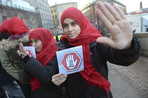 Two young girls carrying leaflets saying "don't touch my mosque" participate in a demonstration at the house of parliament in Stockholm on January 2, 2015. More than a thousand protesters took to the streets in Sweden Friday calling for an end to attacks on mosques, amid growing tensions over rising support for a far right anti-immigration party. The demonstrations in Sweden's three largest cities, Stockholm, Malmoe and Gothenburg, came a day after what was believed to be the third arson attack on a mosque in the space of a week.   AFP PHOTO / TT NEWS AGENCY / FREDRIK SANDBERG   +++ SWEDEN OUT +++