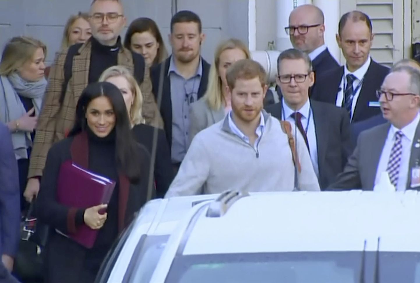 Britain's Prince Harry, center right, and his wife Meghan, center left, Duke and Duchess of Sussex, approach a car at an airport in Sydney, Monday, Oct. 15, 2018. Prince Harry and his wife Meghan arrived in Sydney on Monday, a day before they officially start a 16-day tour of Australia and the South Pacific.(Australian Pool via AP)
