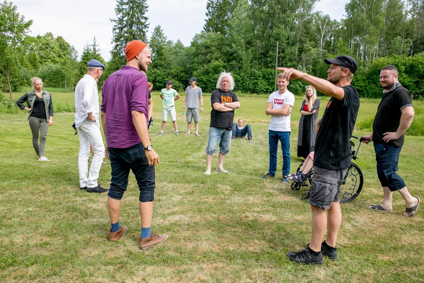 Lavastaja Peep Maasik (vasakul) &shy;tutvustamas meeskonnale mänguplatsi Linnamehe puhkekeskuse õuel.