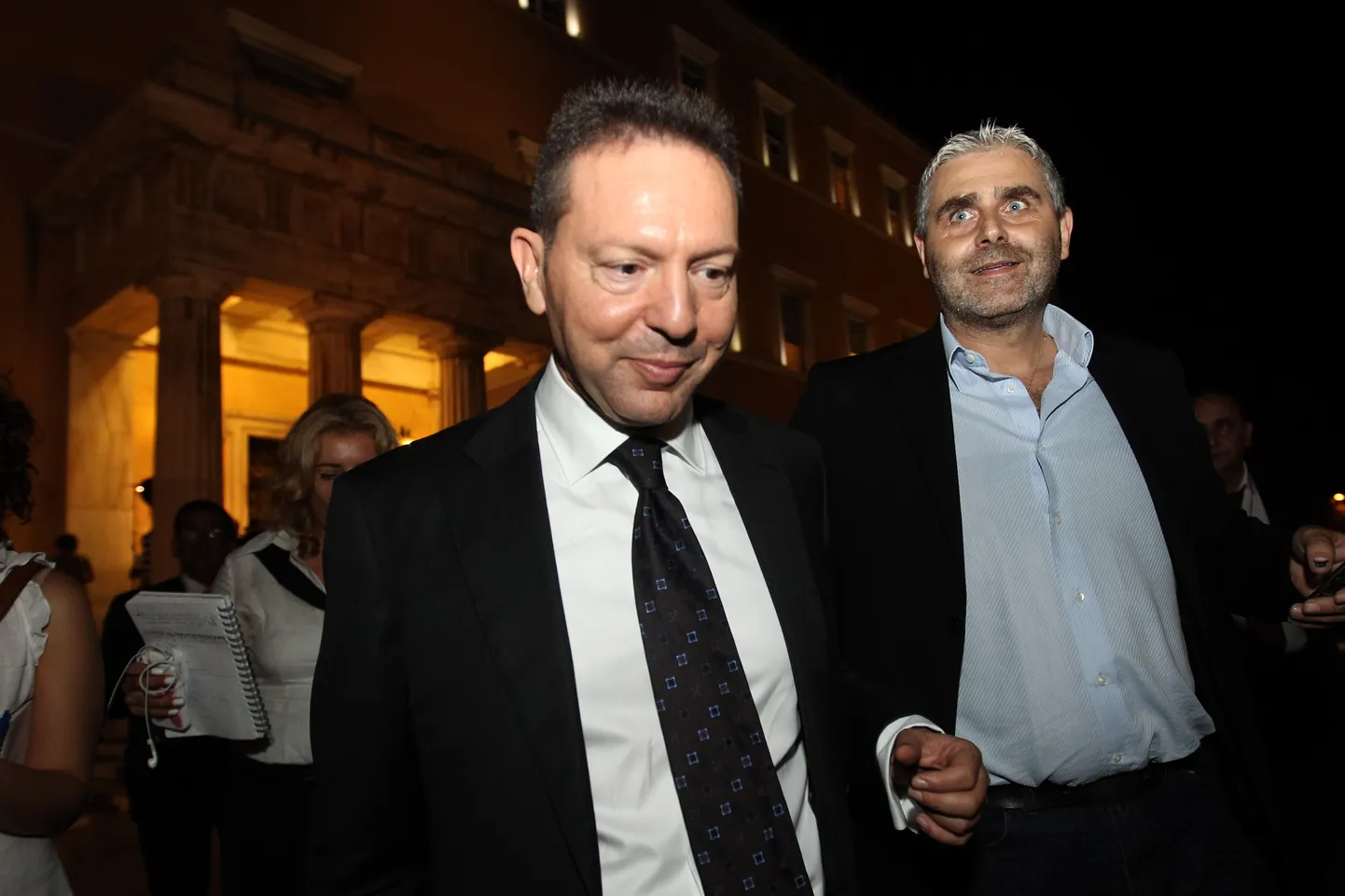 Greek Finance Minister, Yannis Stournaras, left, leaves the Greek parliament after a meeting  between the heads of the three parties in the four-month-old, conservative-led coalition in Athens, Tuesday, Oct. 16, 2012. The head of a small center-left partner in GreeceÕs governing coalition on Tuesday ruled out new reforms demanded by bailout creditors, which he said would ÒcrushÓ labor rights in the debt-crippled country. (AP Photo/Petros Giannakouris) / SCANPIX Code: 436
