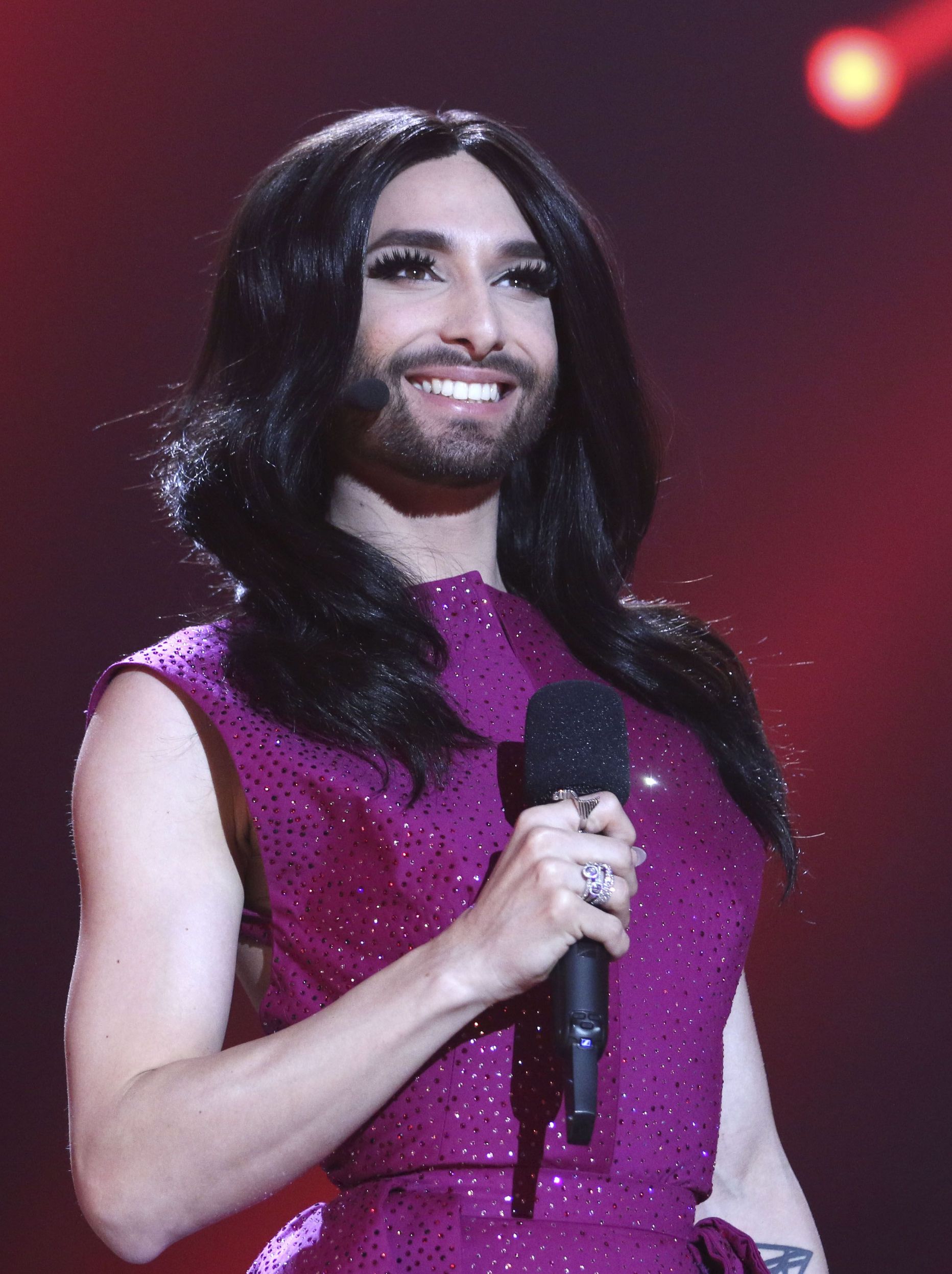 Conchita Wurst, who won the 2014 ESC for Austria, smiles on stage during a dress rehearsal for the final of the Eurovision Song Contest in Austria's capital Vienna, Friday, May 22, 2015. (AP Photo/Ronald Zak)