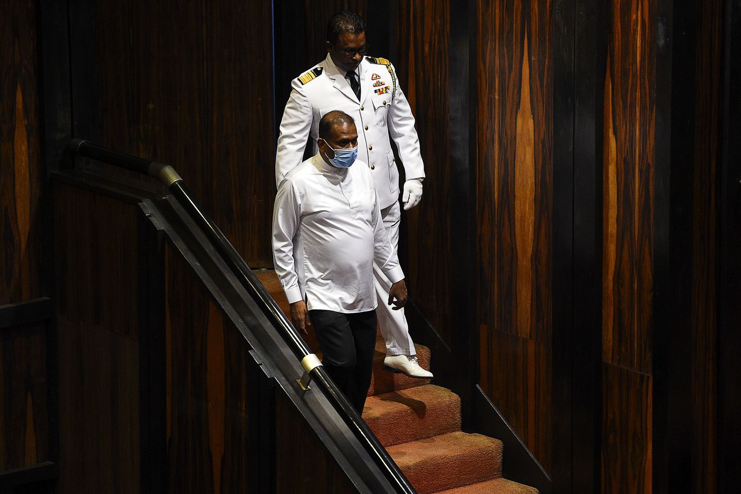 Sri Lanka's convicted murderer Premalal Jayasekara (L) arrives for a sworn in as a member of parliament from the ruling party in Colombo on September 8, 2020. - Jayasekara becomes the first convict facing a death sentence to become a legislator in Sri Lanka. (Photo by ISHARA S. KODIKARA / AFP)