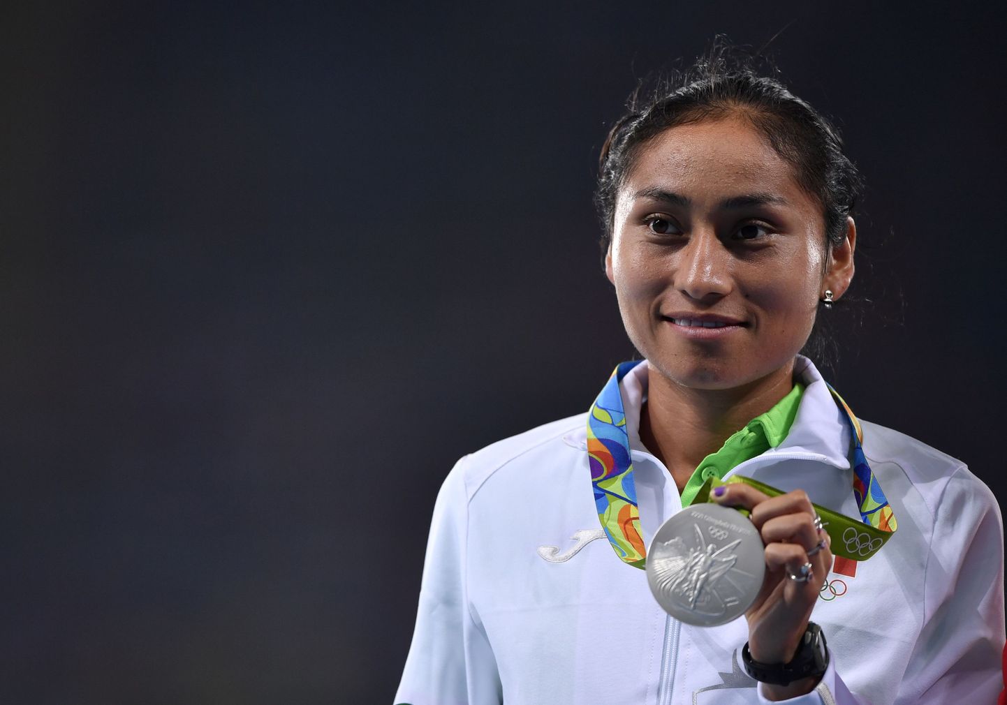 (LtoR) Mexico's Maria Guadalupe Gonzalez (silver medal) poses during the podium ceremony for the Women's 20km Race Walk during the athletics event at the Rio 2016 Olympic stadium in Rio de Janeiro on August 19, 2016.   / AFP PHOTO / Fabrice COFFRINI