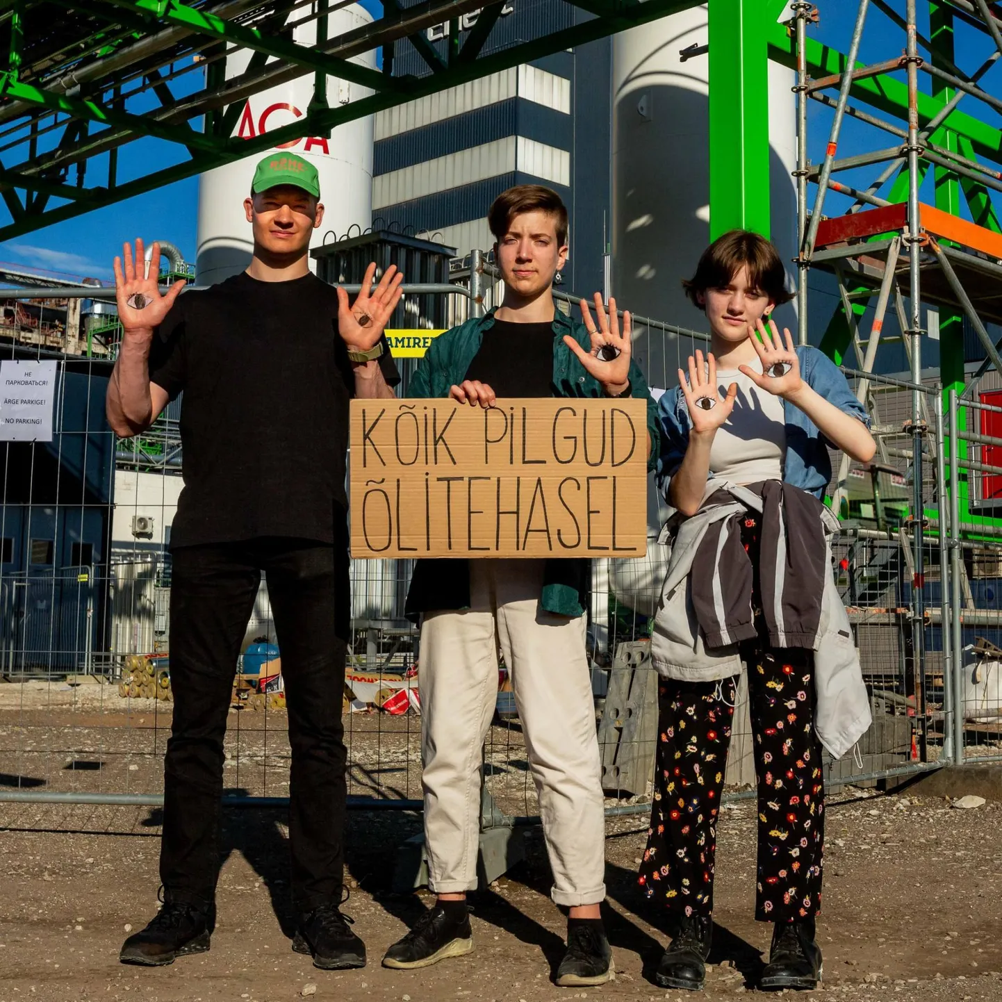 Fridays for Future’i Eesti liikmed Robert Pappel, Kertu Birgit Anton (keskel) ja Elo-Lee Maran selle aasta juunis protestiplakatiga Eesti Energia Auvere elektrijaama ja õlitehase aia taga.

FOTO: Mirabell Veli/Fridays For Future Eesti