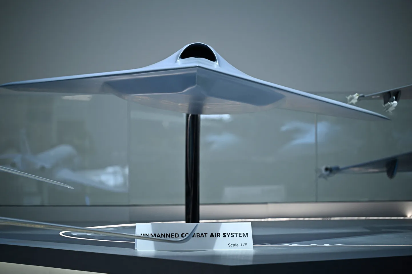 This photograph shows a mock up of a UCAV Unmaned Combat Air System drone - companion of Rafale F5 fighter jets displayed at the pavillon of French aircraft business company Dassault Aviation during the 55th edition of the International Paris Air Show (Salon international de l'aeronautique et de l'espace - SIAE) at the ParisLe Bourget Airport, in Le Bourget, north of Paris on June 18, 2025. (Photo by JULIEN DE ROSA / AFP)
