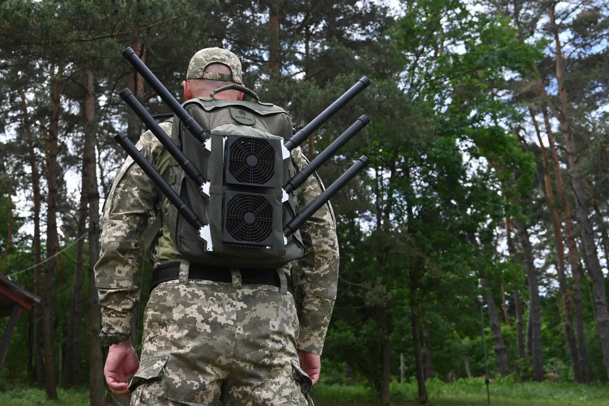 A Ukrainian serviceman tests an anti-drone backpack during a presentation of radio-electronic warfare (WB) and radio-electronic intelligence (PER) systems of the Ukrainian company Kvertus.