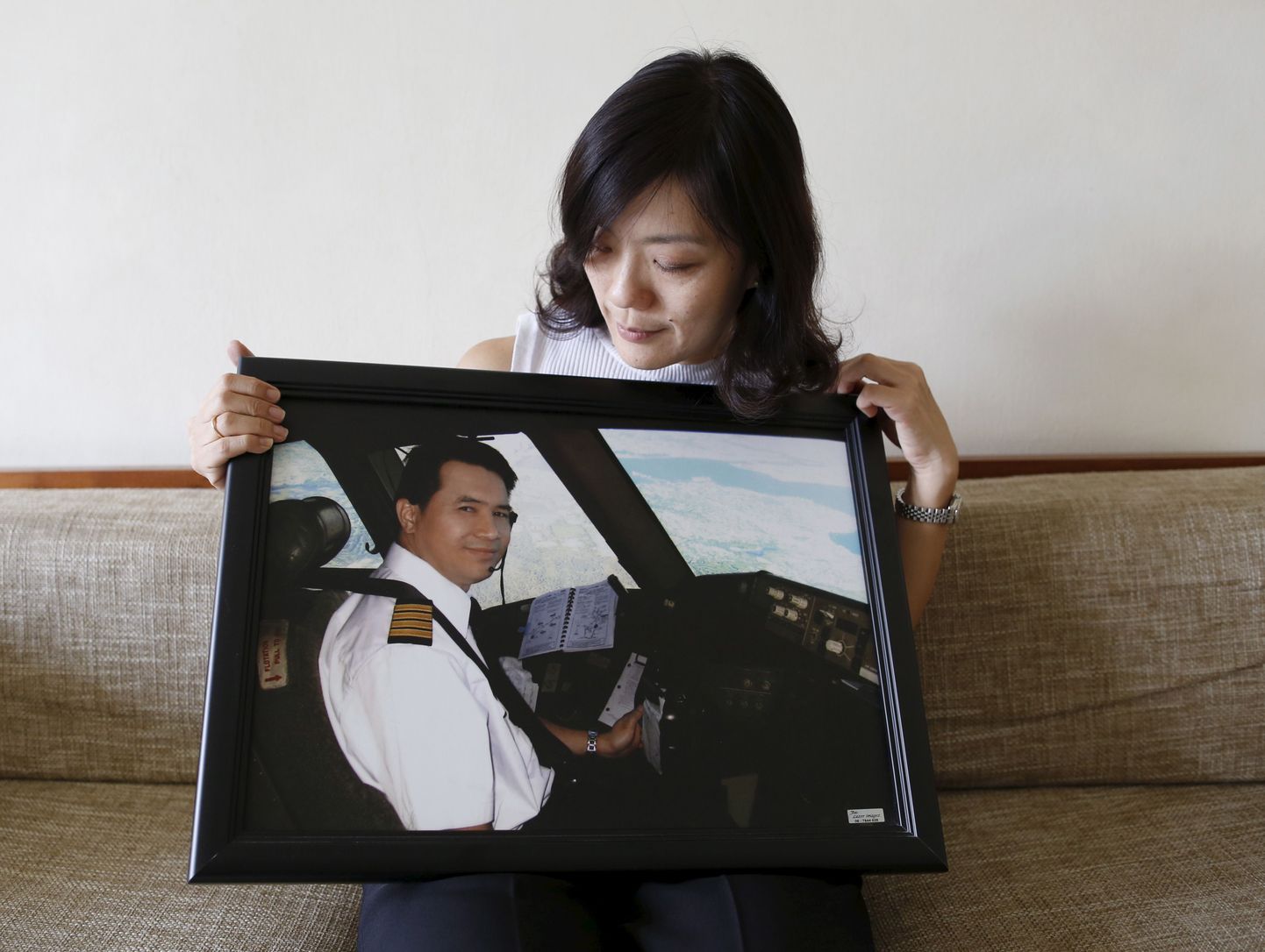 Malaysia Airlinesi piloodi Eugene Choo lesk Ivy Loi näitamas oma mehe fotot