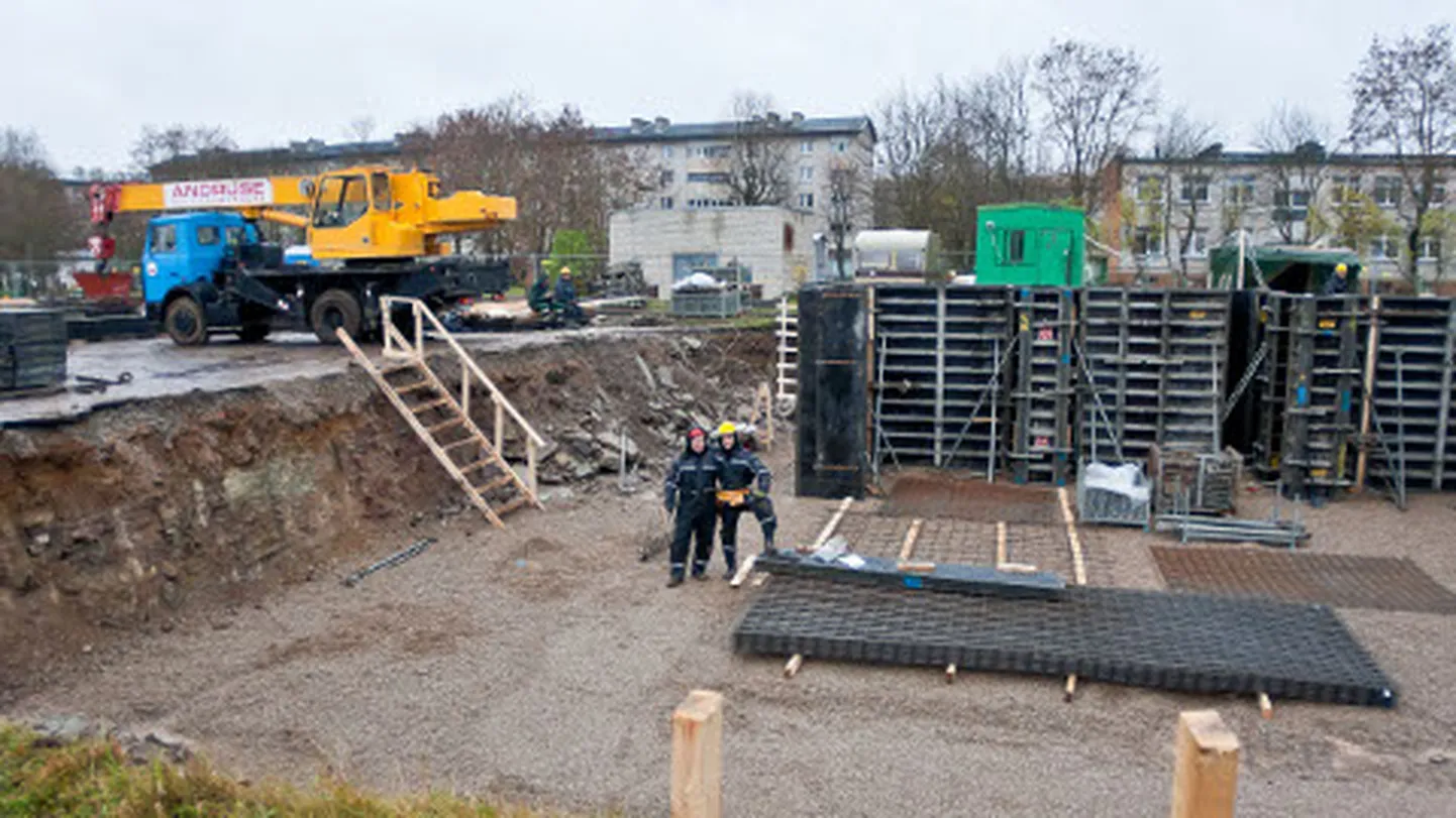 Ehitusplatsil valmistatakse ette Narva uue kiriku soklikorruse betoonivalu. Fotograafile poseerides naljatavad ehitajad, et ehk jäävad nad pildile aupaistega.