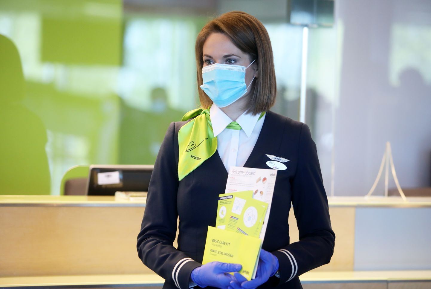 Nacionālās lidsabiedrības "airBaltic" stjuarte ar informatīviem materiāliem preses konferences laikā, kurā tiek informēts par lidojumu atsākšanu starp Baltijas valstīm, kā arī lidostā un "airBaltic" ieviestajiem epidemioloģiskās drošības pasākumiem  Covid-19 pandēmijas laikā.