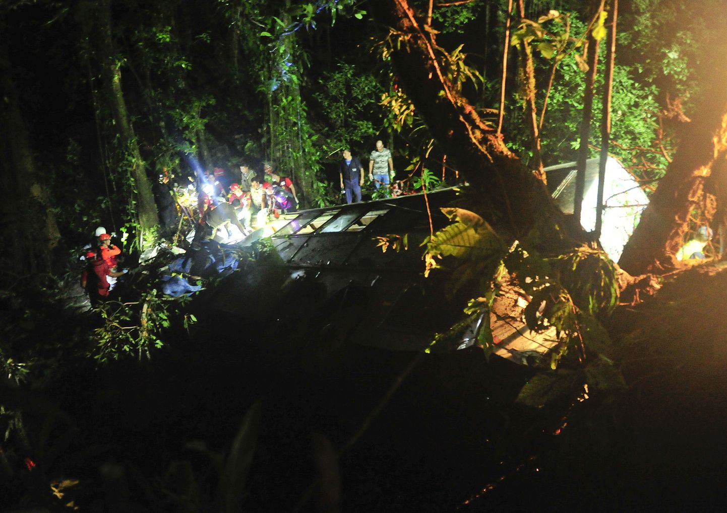 Rescue personnel work at the site where a tourist bus crashed killing at least 49 people, according to the the Santa Catarina State security secretary, near the city of Joinville, southern state of Santa Catarina, Brazil, Saturday, March 14, 2015. (AP Photo/Salmo Duarte, Agence RBS)