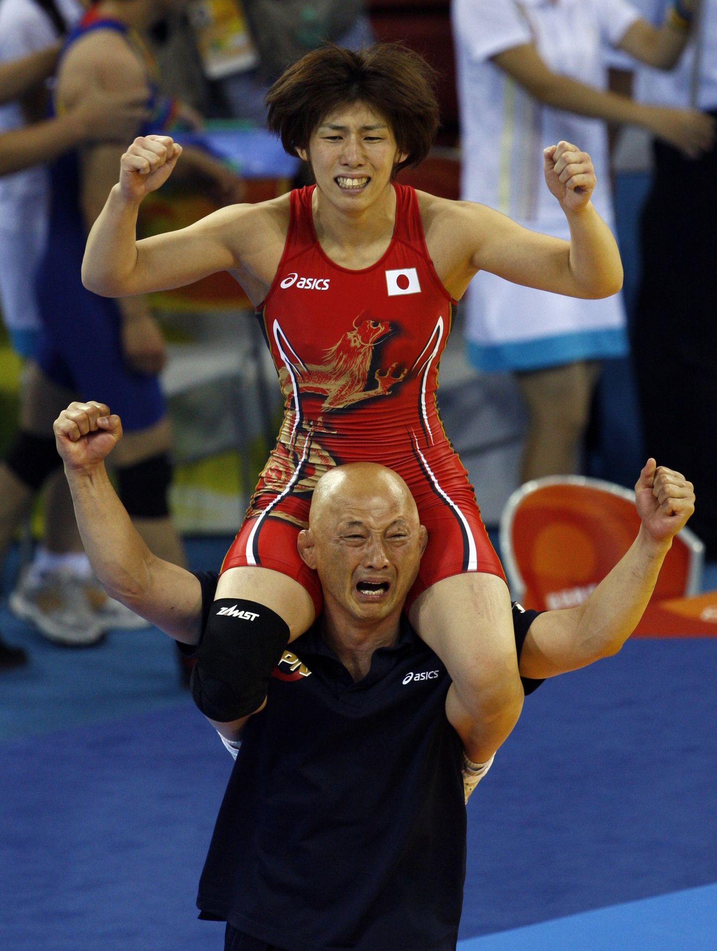 Saori Yoshida ronis pärast võitu treeneri kukile.