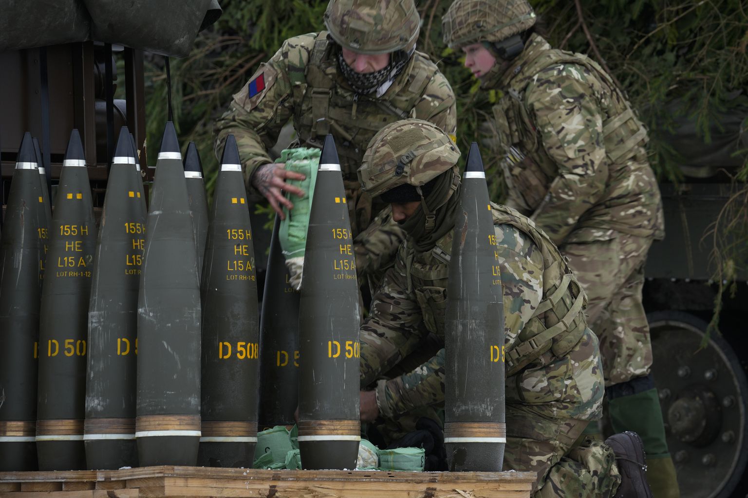 British soldiers prepare shells of AS-90 self-propelled artillery weapon during the Winter Camp 23 military drills near Tapa, Estonia, Tuesday, Feb. 7, 2023.