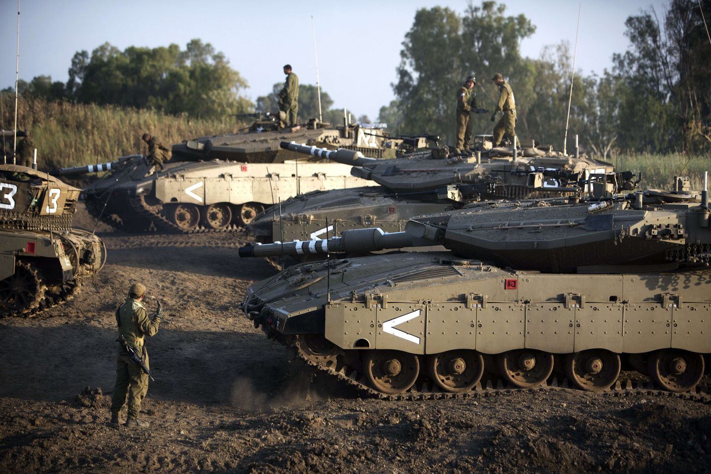 TOPSHOTS
Israeli soldiers are seen with their Merkava tank unit deployed in the Israeli annexed Golan Heights near the border with Syria, on May 6, 2013. UN chief Ban Ki-moon has appealed for restraint after Israeli air strikes on targets near Damascus which prompted Syrian officials to warn "missiles are ready" to retaliate.   AFP PHOTO/MENAHEM KAHANA