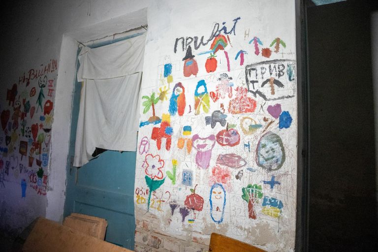 Children's drawings on the basement walls. 