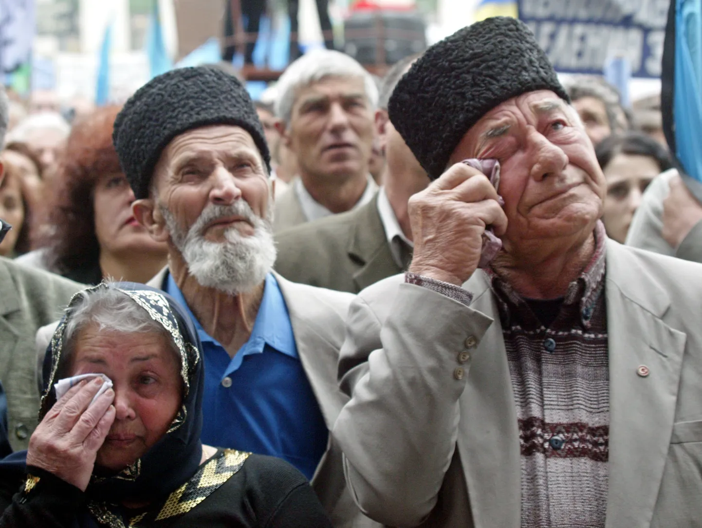 Crimean Tatars wipe away their tears at a mourning rally on May 18, 2004 during the 60th anniversary of deportation of ethnic Tatars under Soviet dictator Josef Stalin, in the Crimean capital of Simferopol, Ukraine.