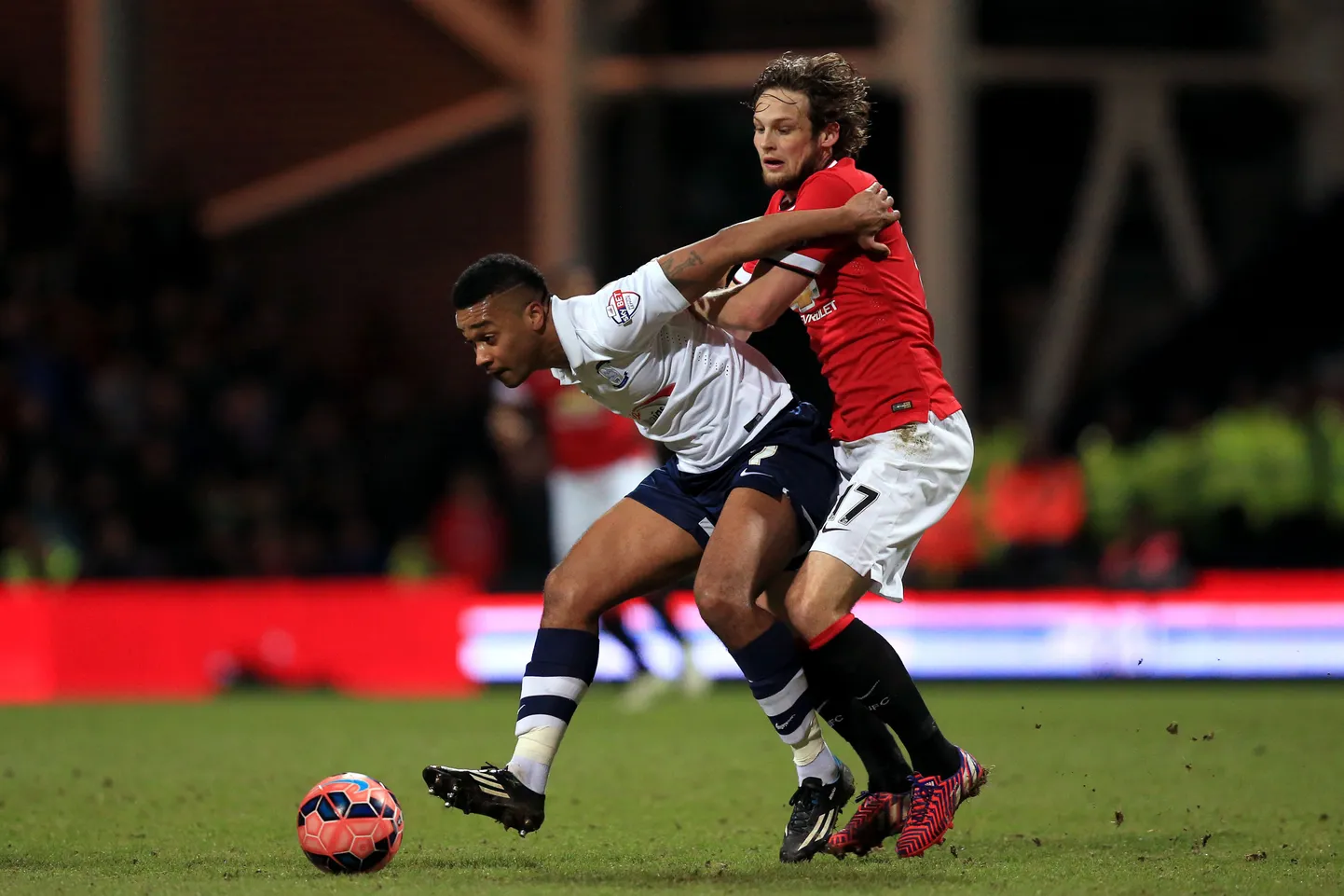 Manchester United's Daley Blind (right) and Preston North End's Chris Humphrey (left) battle for the ball.