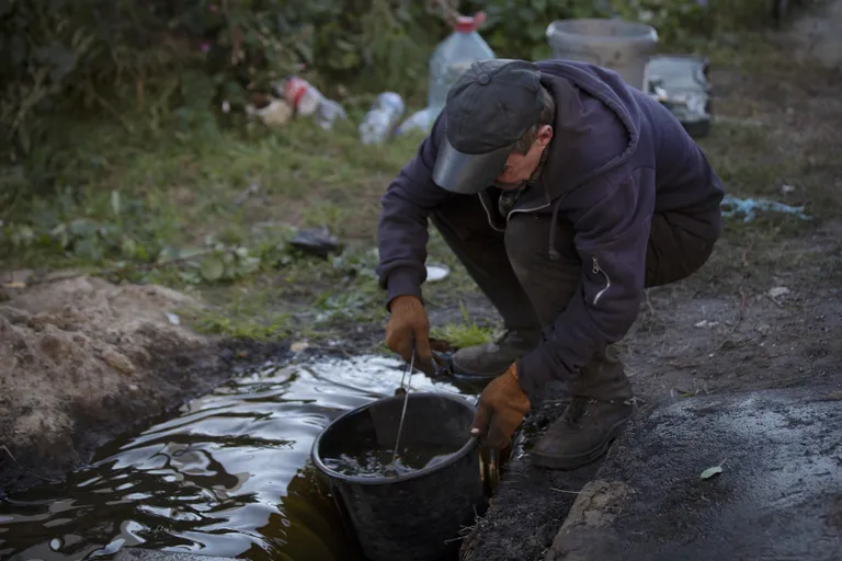 Everything handy was used to collect the sunflower oil that flowed in streams.