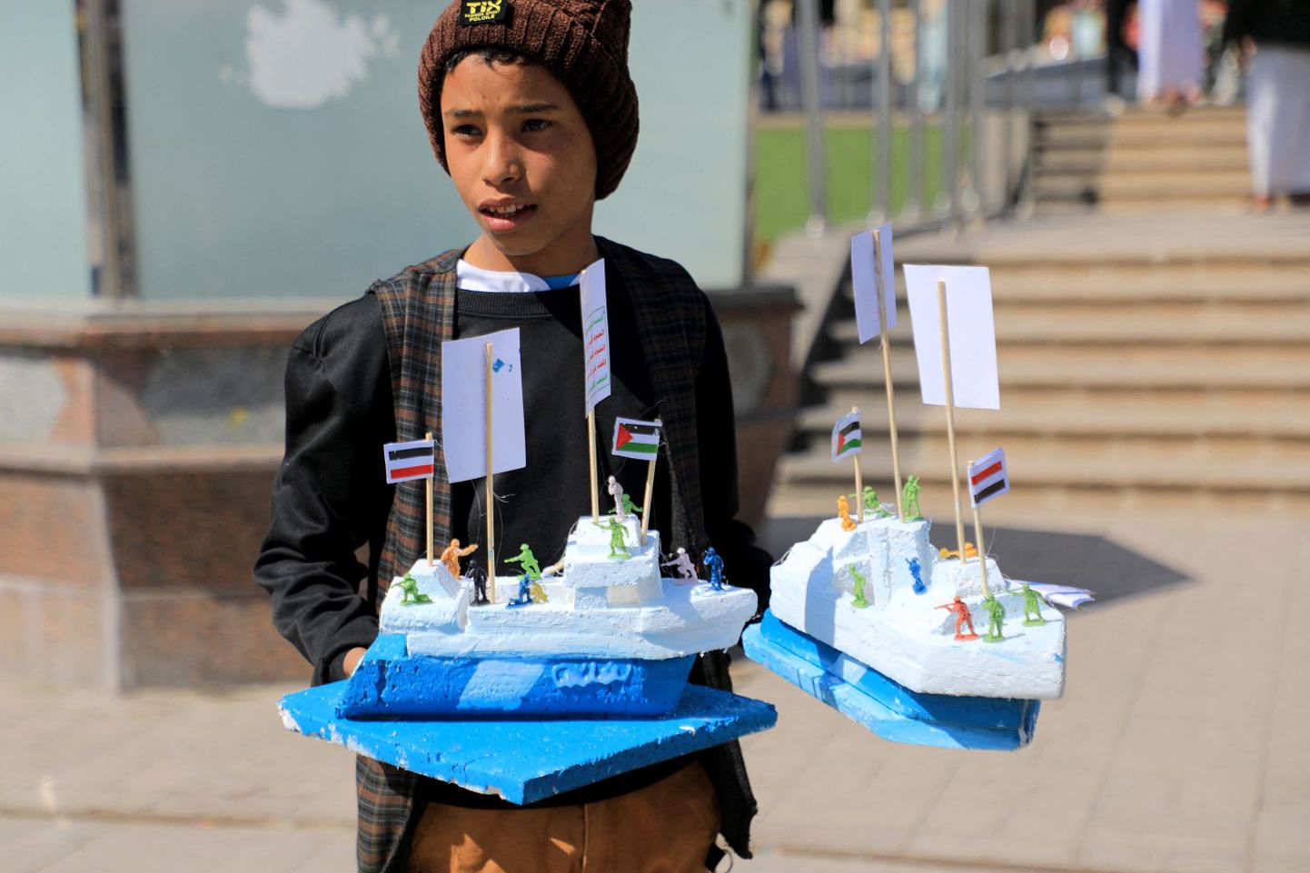 Jeemeni poiss müümas kaaperdatud kaubalaeva kujukesi.