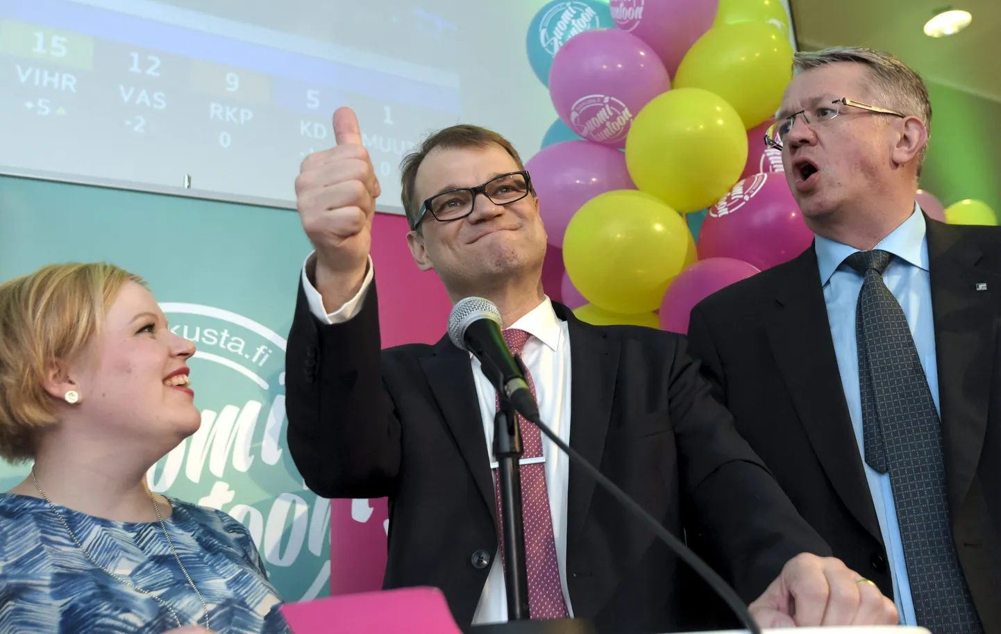 Annika Saarikko (vasakul), Keskerakonna esimees Juha Sipilä (keskel) ning Juha Rehula (paremal) tähistamas erakonna võitu parlamendivalimistel.