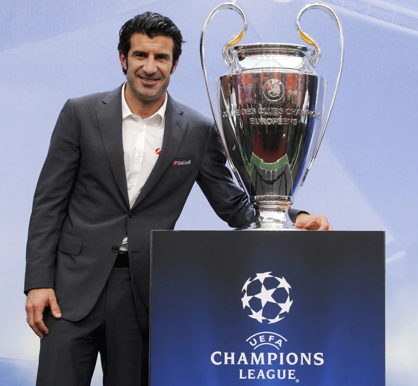 Portuguese soccer legend Luis Figo poses with the Champions League trophy after a news conference during UEFA Champions League Trophy Tour 2010 at the Milan Rastislav Stefanik square in Bratislava October 8, 2010. REUTERS/Radovan Stoklasa (SLOVAKIA - Tags: SPORT SOCCER)
