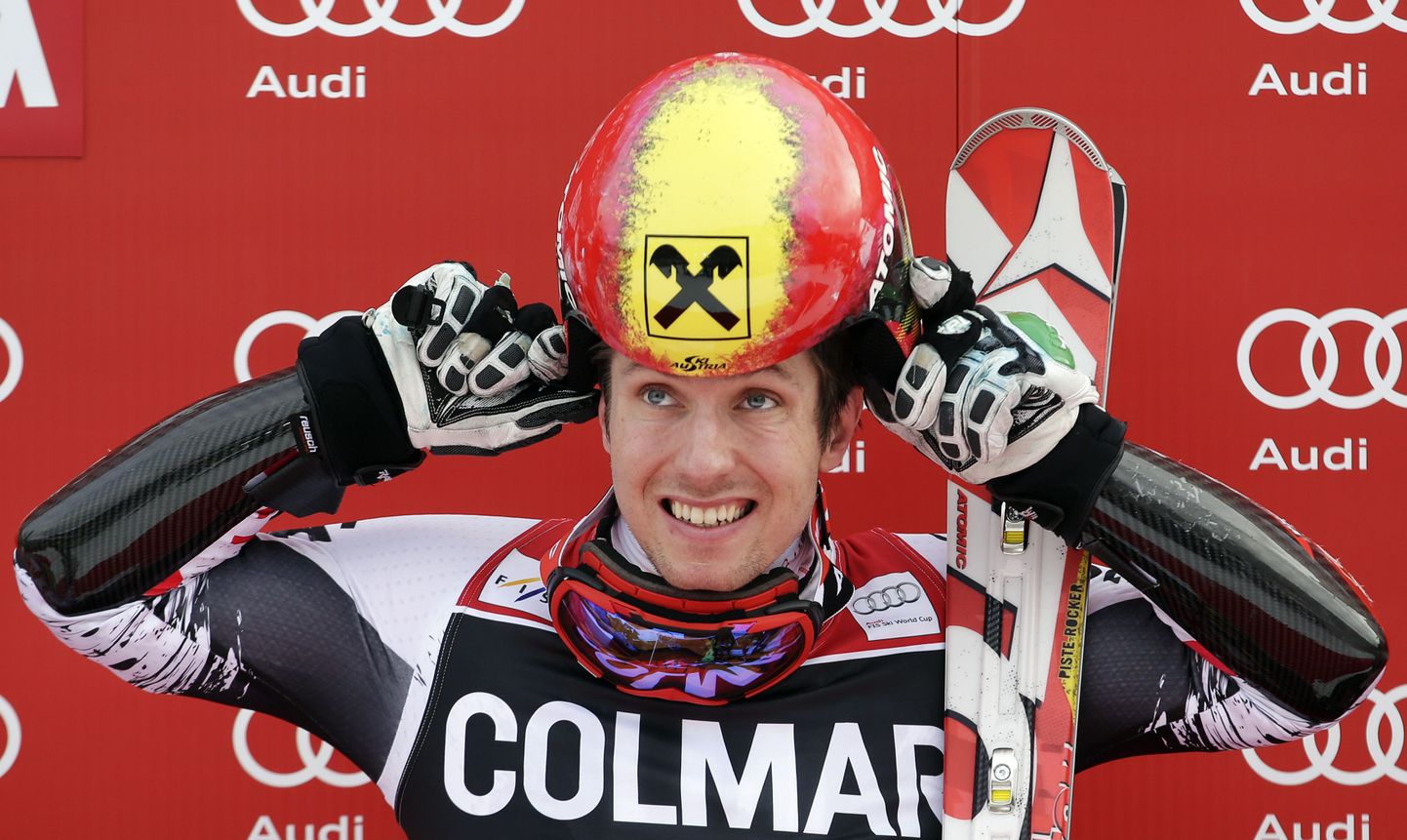 Marcel Hirscher of Austria takes off his helmet on the podium after winning in the men's World Cup Giant Slalom skiing race in Alta Badia December 22, 2013. REUTERS/Max Rossi  (ITALY - Tags: SPORT SKIING)