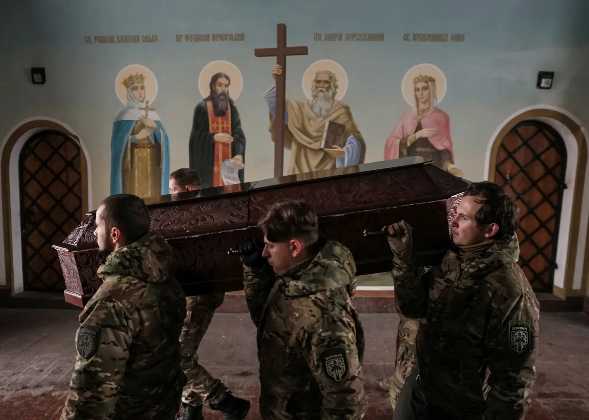 Members of the Ukrainian volunteer paramedic organization Hospitallers carry a coffin with the body of one of the organization's members, a Swedish citizen nicknamed Niko, 20, who was killed near Bakhmut amid Russia's attack on Ukraine.