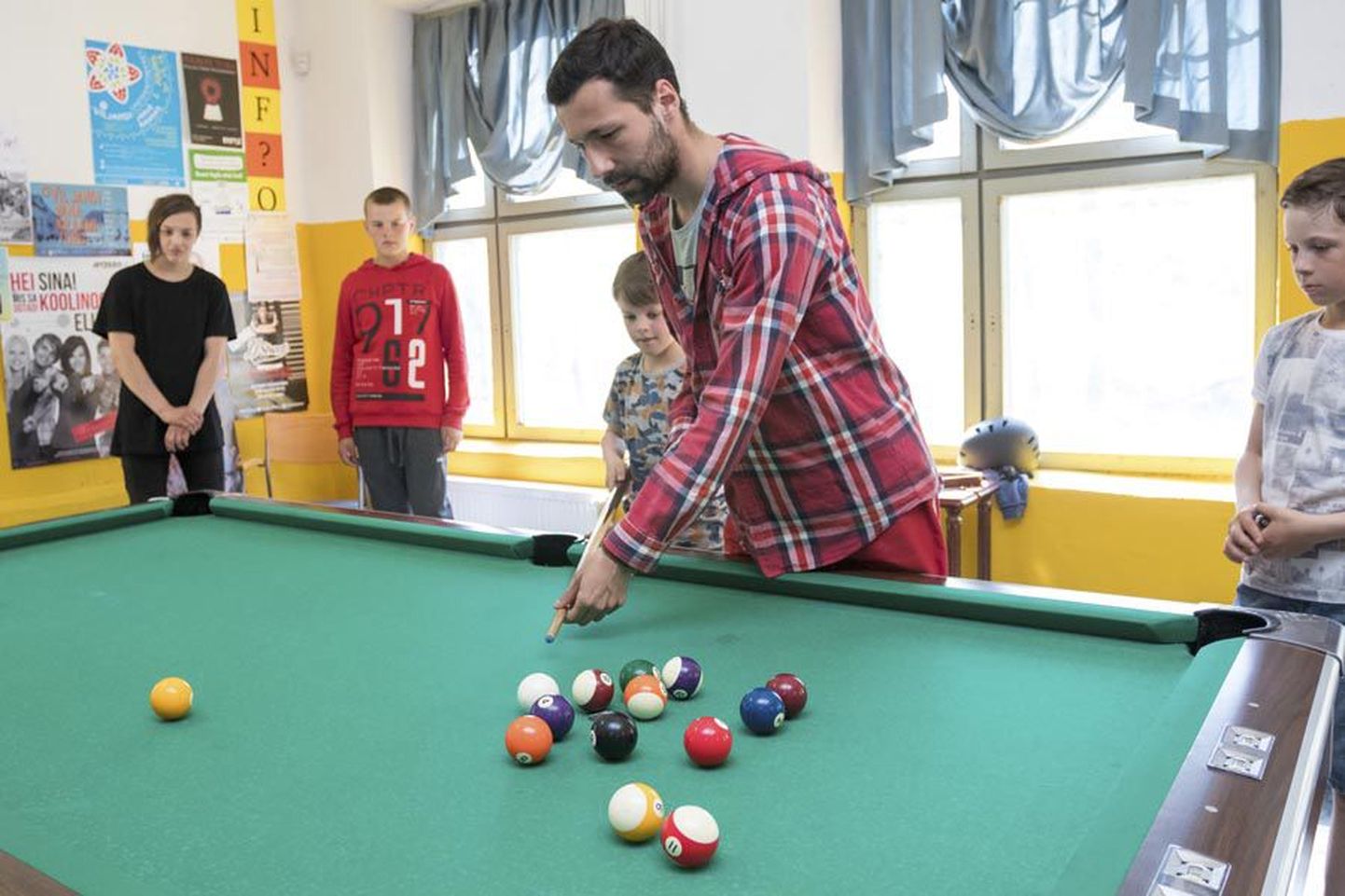 Vabatahtlik Jakub Zygmunt ei pea paljuks teiste töökohustuste kõrvalt noortetoas lastele piljardimängu õpetada.