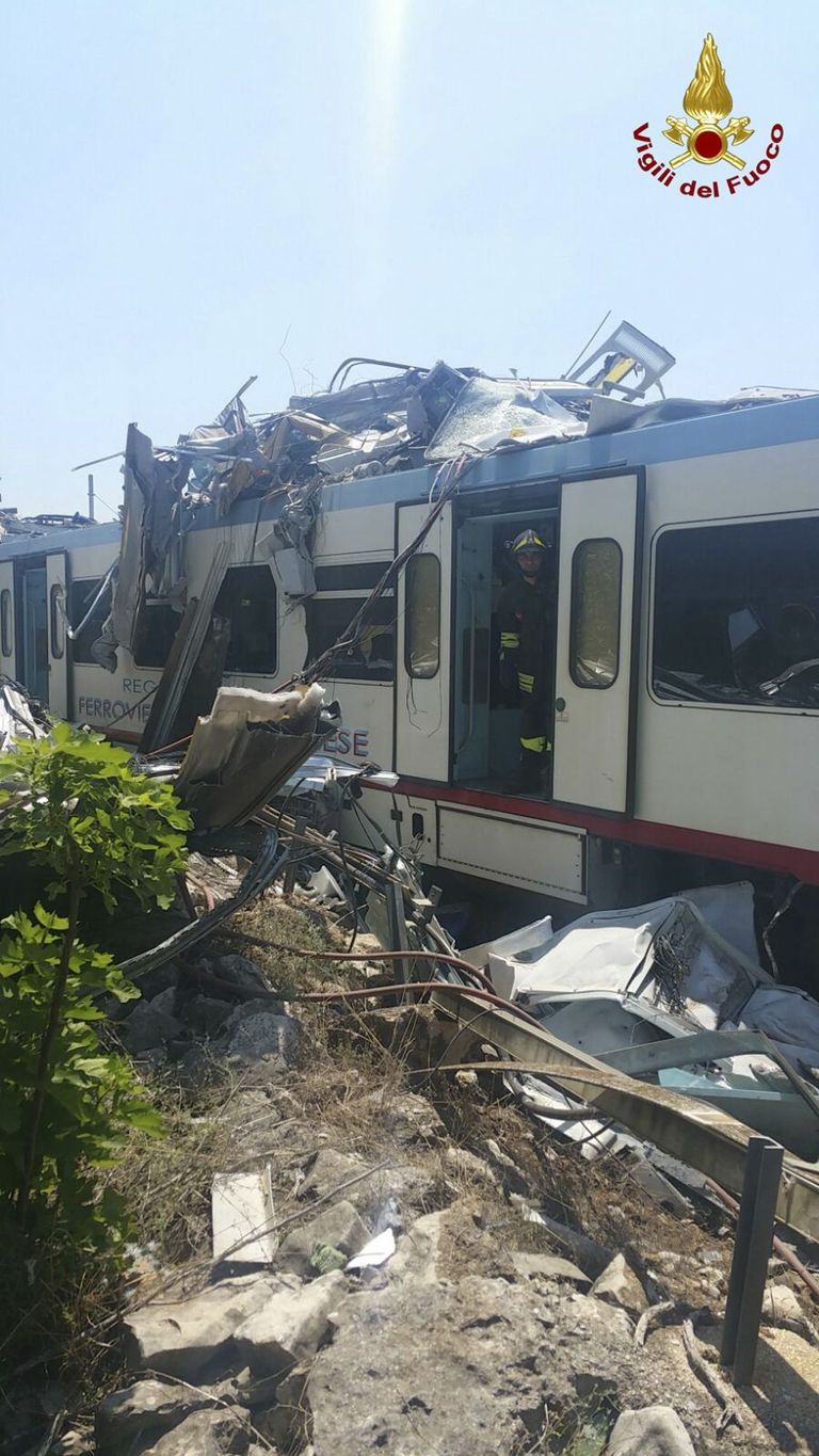 The wreckage of a crumpled wagon at the scene of a train accident after two commuter trains collided head-on in the southern region of Puglia, killing several people, Tuesday, July 12, 2016.  (Italian Firefighter Press Office via AP)