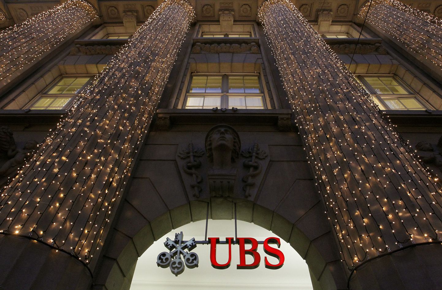 Christmas lights are illuminated at an office building of Swiss bank UBS in Zurich in this file photo taken December 4, 2012.  UBS faces a combined fine of around $1 billion next week to settle charges of rigging the Libor interest rate benchmark, a person familiar with the situation said on Thursday.  REUTERS/Arnd Wiegmann/Files  (SWITZERLAND - Tags: BUSINESS CRIME LAW)
