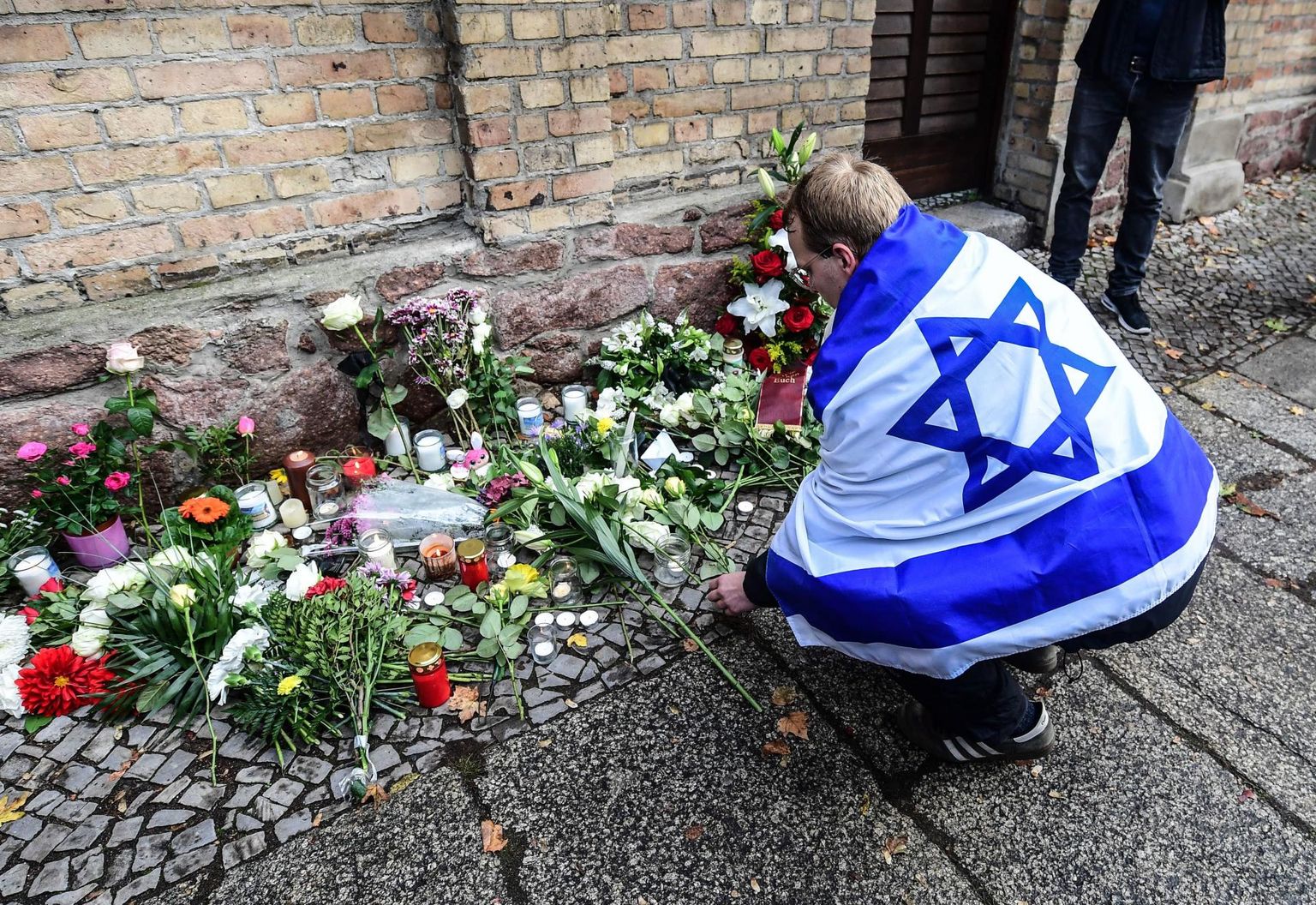Juudivastased rünnakud Euroopas on viimastel aastatel sagenenud ja uuringute järgi tajub seda ligi 90 protsenti Euroopas elavatest juutidest. Pildil mälestab Iisraeli lipuga mees 2019. aasta oktoobris Saksamaal Halles rünnakus sünangoogile hukkunuid. 