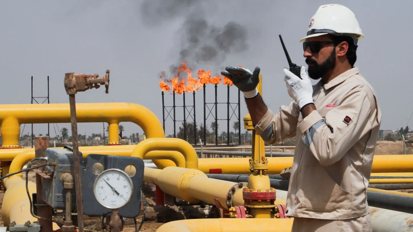 A worker uses a handheld radio at Nahr Bin Umar oil field, north of Basra, Iraq March 22, 2022. REUTERS/Essam Al-Sudani