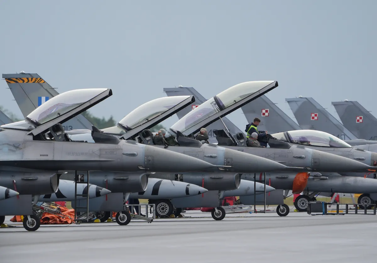 11 June 2024, Schleswig-Holstein, Jagel: Pilots prepare in the cockpits of their F-16 fighter jets for the flight during the NATO air force maneuver "Tiger Meet".