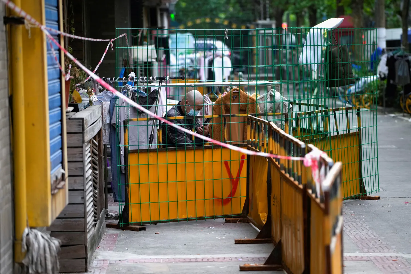 Shanghai elanik vaatab telefoniekraani eile tara taga linna blokeeritud piirkonnas.