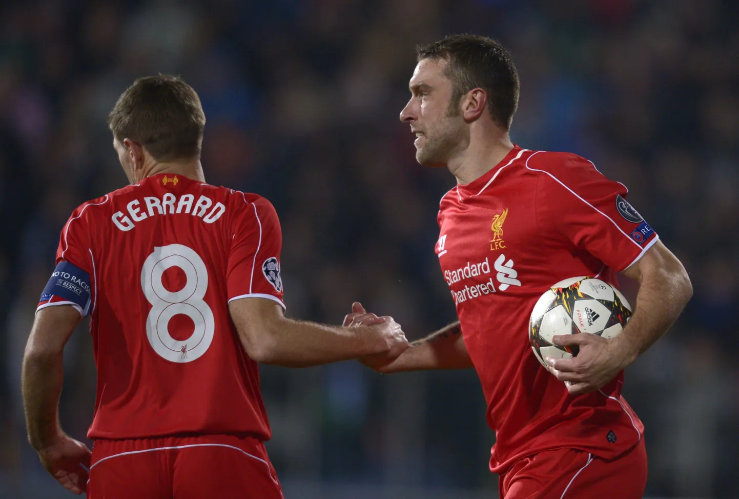 Liverpool midfielder Steven Gerrard congratulates Liverpool striker Rickie Lambert for his goal on November 26, 2014 during a UEFA Champions League Group B match between Ludogorets Razgrad and Liverpool FC at the Vassil Levski stadium in Sofia. AFP PHOTO / NIKOLAY DOYCHINOV