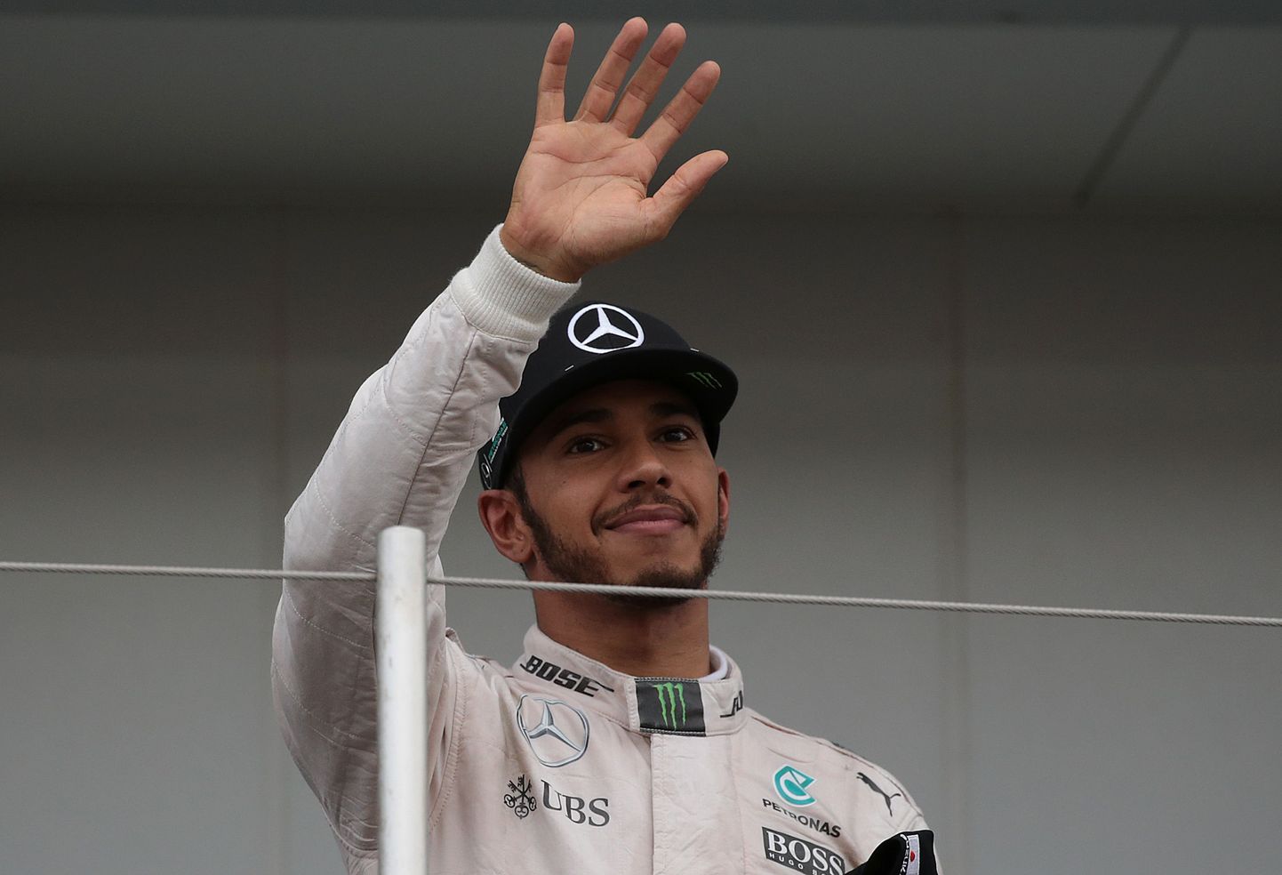 Third-placed Mercedes AMG Petronas F1 Team's British driver Lewis Hamilton waves as he leaves the podium after the Formula One Japanese Grand Prix at the Suzuka Circuit on October 9, 2016.  / AFP PHOTO / YUYA SHINO