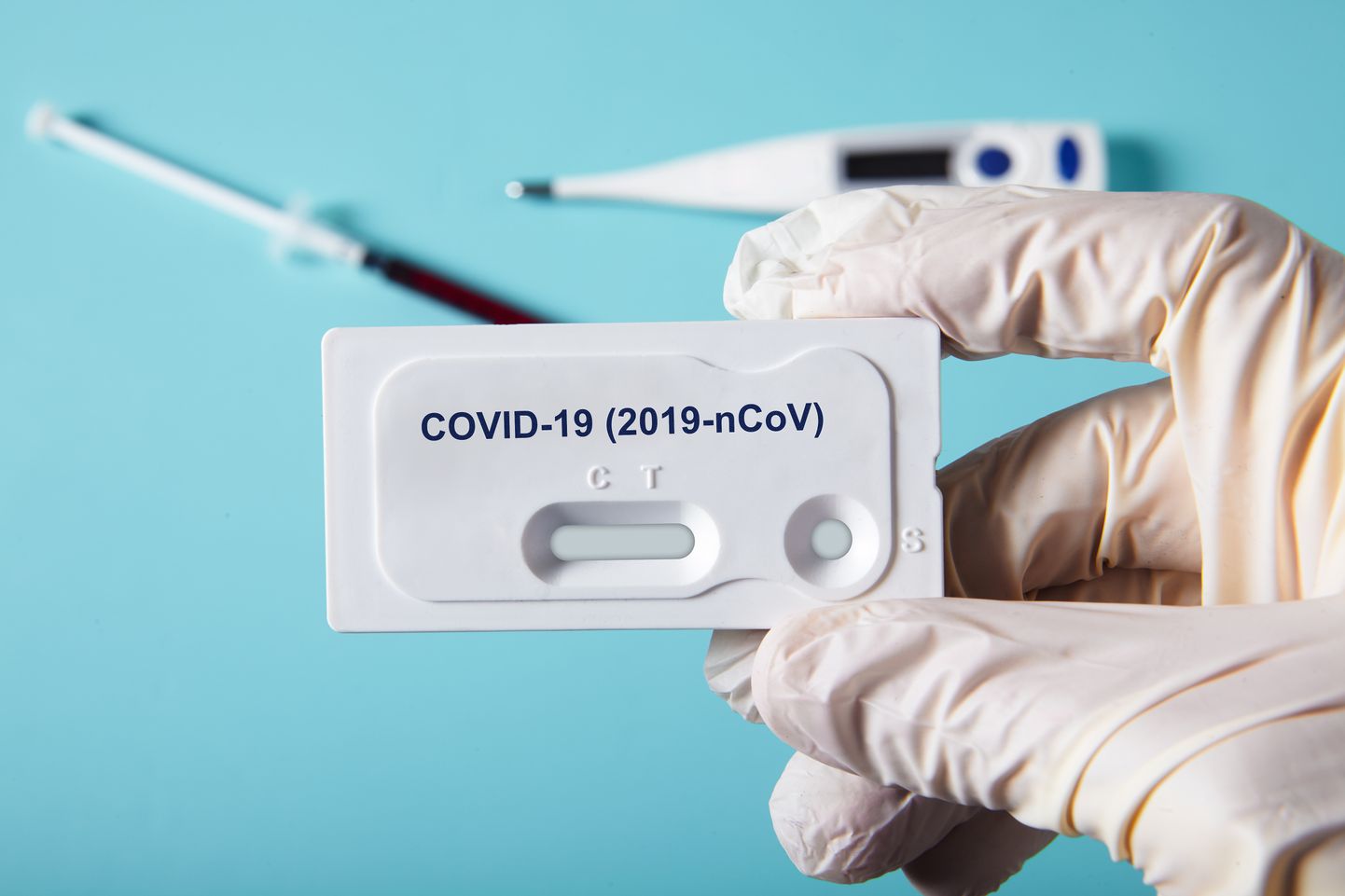 Doctor holding a test kit for viral disease COVID-19 2019-nCoV. Lab card kit test for viral novel coronavirus sars-cov-2 virus