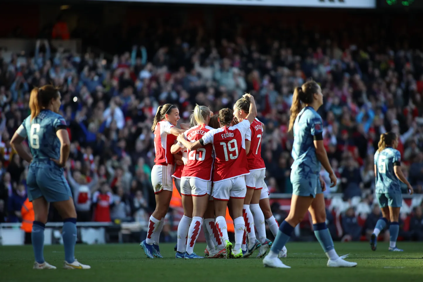 Женская футбольная команда лондонского "Арсенала" празднует победу.