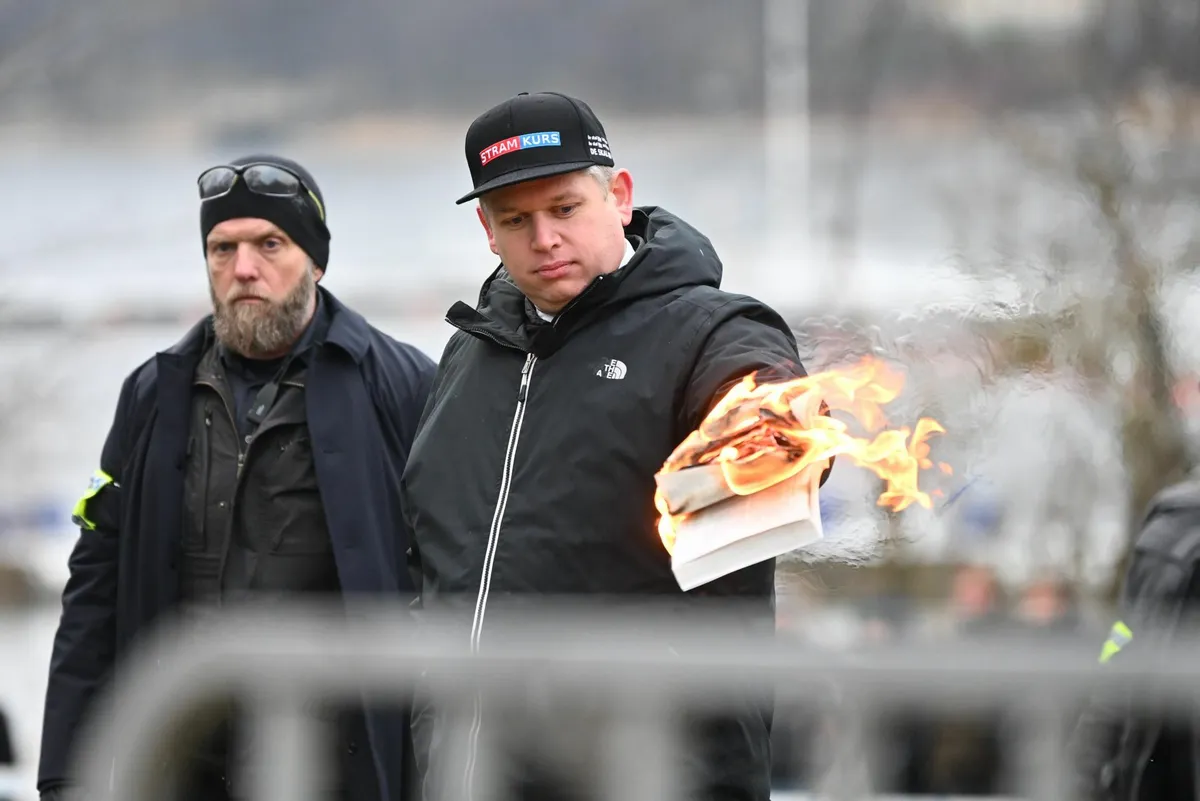 Rasmus Paludan burning the Quran in front of the Turkish embassy in Stockholm.